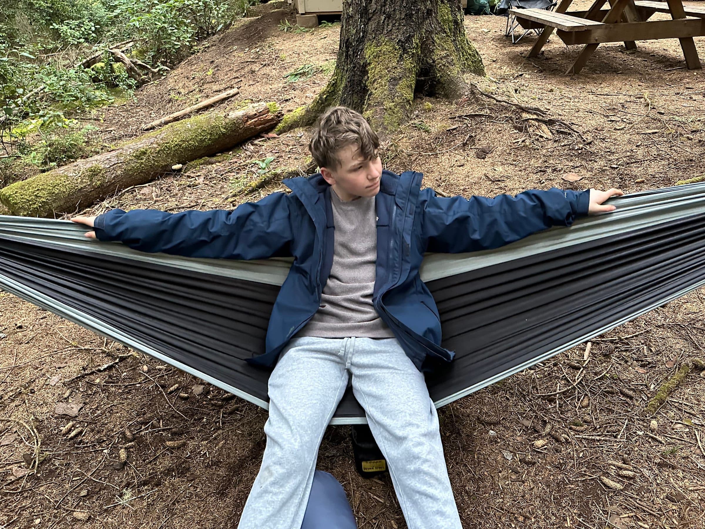Asher relaxing in a hammock at Camp Meriwether
